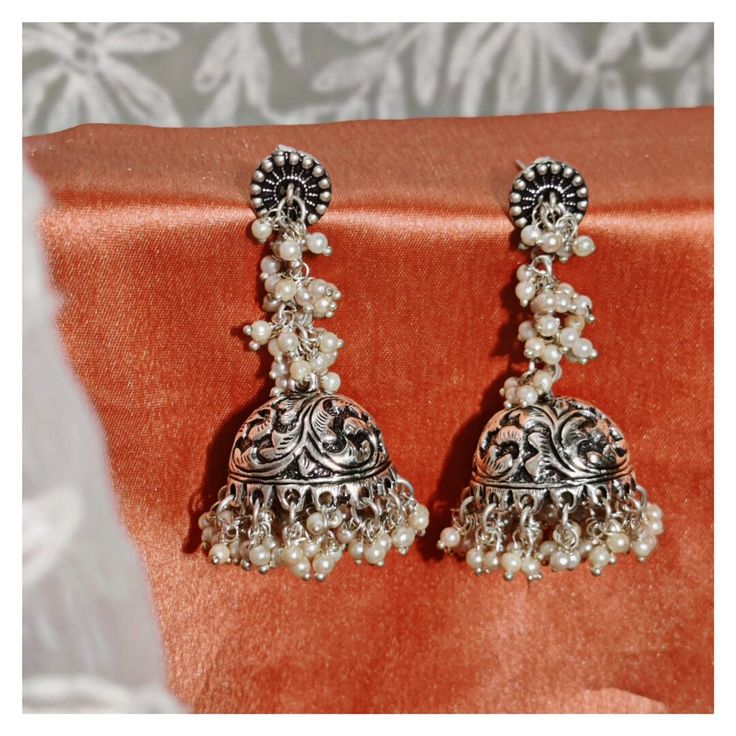 Stunning heavy look ethnic earrings  jhumka jhumki stud Afghani earrings in silver tone  With intricate carved work and sparkling ghunghroos which gives a traditional touch to the earrings  Perfect with ethnic and traditional wear  Can be a perfect gifting option for friends and dear ones  Silver metallic ghunghroo tinkle to create a striking look  With intricate carved word and sparkling ghunghroo which gives a traditional touch to the earring. Silver metallic base tinkle to create a striking l Silver Jhumkas For Navratri, Sterling Silver Bohemian Jhumkas, Bohemian Sterling Silver Drop Jhumkas, Handmade Silver Bohemian Jhumkas, Bohemian Sterling Silver Jhumkas For Festivals, Silver Bohemian Style Drop Jhumkas, Silver Jhumkas For Festival, Elegant Silver Jhumkas For Festival, Bohemian Silver Handmade Jhumkas