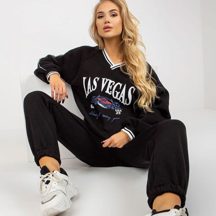 Bring style to your workout or casual days with our Las Vegas Black Sports Tracksuit Set. This dynamic ensemble includes a sweatshirt designed with long sleeves and a heart neckline, adding a touch of flair to your athletic or leisure wardrobe. Paired with comfortable long pants featuring a waist tie and convenient slip pockets, this tracksuit set effortlessly combines fashion and functionality. Crafted from a premium blend of 70% cotton and 30% polyester, it ensures both comfort and durability. Winter Athleisure Tracksuit With Graphic Print, Graphic Print Athleisure Tracksuit, Sporty Winter Tracksuit With Graphic Print, Sporty V-neck Sweatshirt With Ribbed Cuffs, Sportswear Tracksuit With Graphic Print And Long Sleeves, Graphic Print Sportswear Tracksuit, Graphic Print Long Sleeve Sportswear Tracksuit, Graphic Print Long Sleeve Tracksuit, Oversized Sporty V-neck Sweatshirt