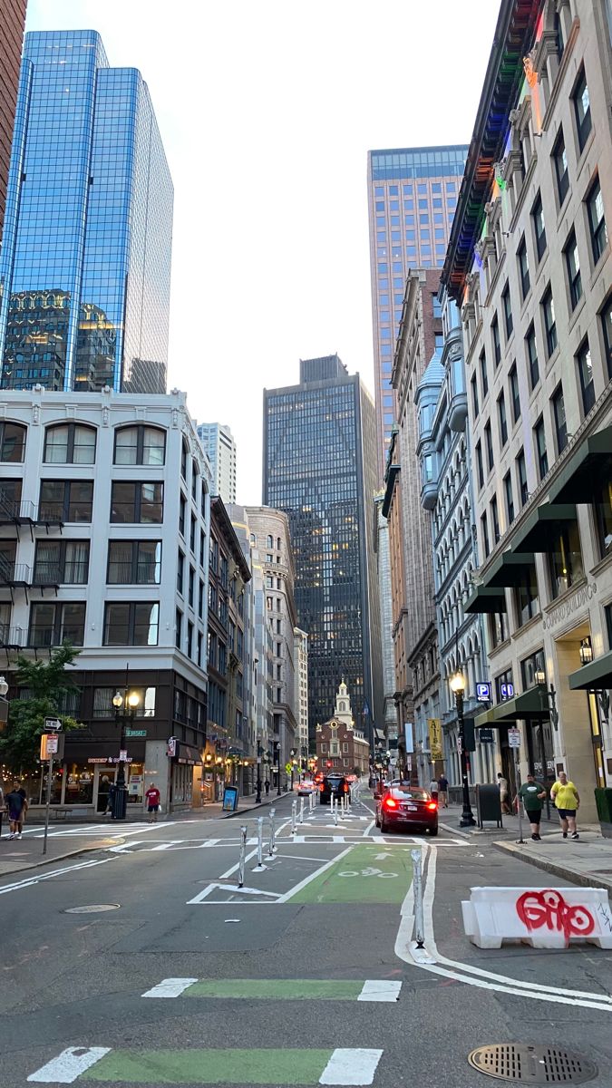 a city street with tall buildings and traffic lights