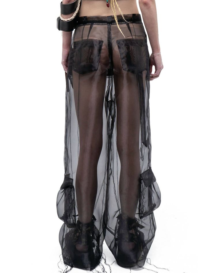 RELAXED-FIT WIDE-LEG LIGHTWEIGHT SEMI-SHEER ORGANZA CARGO PANTS IN BLACK WITH ETHEREAL EFFECT. BELT LOOPS. ZIP-FLY. CONCEALED VELCRO FASTENING AT FRONT WAISTBAND. DARTS AT BACK. 6-POCKET STYLING. LOOSE THREAD OVERLOCK ROOTS DETAILING THROUGHOUT. *MIX WITH SHORTS/LEGGINGS/HALF SKIRT WAIST BAG TO REACH OPACITY, BUT KEEP ETHEREAL EFFECT OF THE LOOK.COMPOSITION & CARE:BODY: ORGANZA100% POLYESTER DRY CLEAN ONLY. MEDIUM TEMP IRON. DO NOT BLEACH.MADE IN UKRAINE MODEL ANDRA IS 5FT 9" (175CM) TALL, CHEST Organza Pants, Made In Ukraine, Tall Chest, Black Cargo Pants, Half Skirt, Black Cargo, Short Leggings, Waist Bag, Cargo Pants