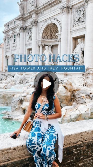 a woman sitting on top of a stone wall next to a fountain