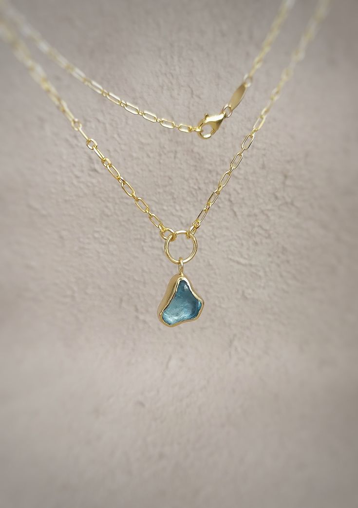 This sterling  silver and gold plated rough aquamarine minimal necklace is handmade and unique. Because of this, there may be small difference in each piece. I used sterling silver chain, sterling silver (925K) and raw aquamarine with silver smithing technique and I made gold plated. You can purchase this elegant and cute aquamarine necklace for yourself or as a christmas gift and mother's day gift. This unique aquamarine necklace that looks like a water drop is suitable for daily use. Aquamarin Handmade Aquamarine Pendant Necklace, Gold Aquamarine Pendant Necklace, Blue Gemstone Jewelry In Recycled Gold, Minimalist Gold Jewelry With Blue Topaz, Gold Aquamarine Birthstone Necklace, Yellow Gold Aquamarine Pendant Jewelry, Minimalist Gold Aquamarine Jewelry, Gold Aquamarine Jewelry With Natural Stones, Handmade Gold Necklaces With Blue Topaz