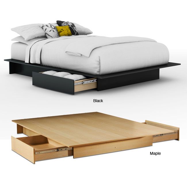 the bed is made up and has two drawers underneath it, as well as an open drawer