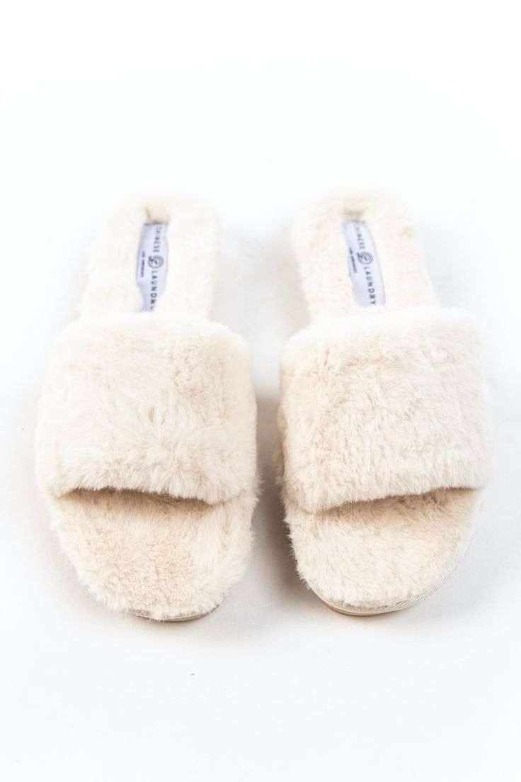 Slideeeee into coziness with the Rally Fluffy Slides! Add softness to every step with these incredible plush house slippers. With a hard textured sole, these slides are great for grabbing the mail on those cold mornings or afternoon walks around the block! *FINAL SALE* Comfortable Slip-on Slippers With Soft Texture, Comfortable Indoor Slides With Round Toe, Comfortable Round Toe Slides For Indoor Use, Cream Colored Comfy Slippers With Soft Detailing, Comfy Cream Slippers With Soft Detail, Soft Texture Indoor Slippers With Round Toe, Comfortable Slippers With Soft Texture And Round Toe, Comfortable Slip-on Faux Fur Slippers, Comfortable Flat Faux Fur Slippers