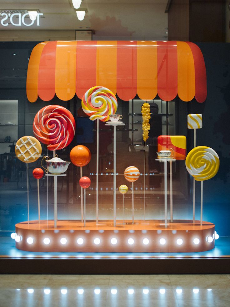 an assortment of lollipops displayed in a store window