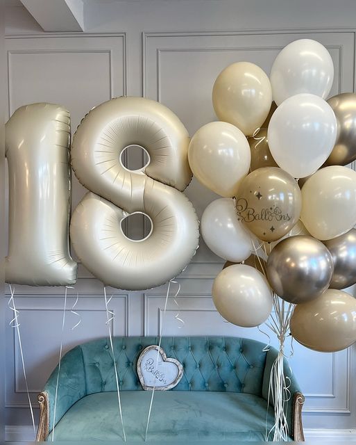 the balloons are in the shape of numbers and have been placed on top of a couch