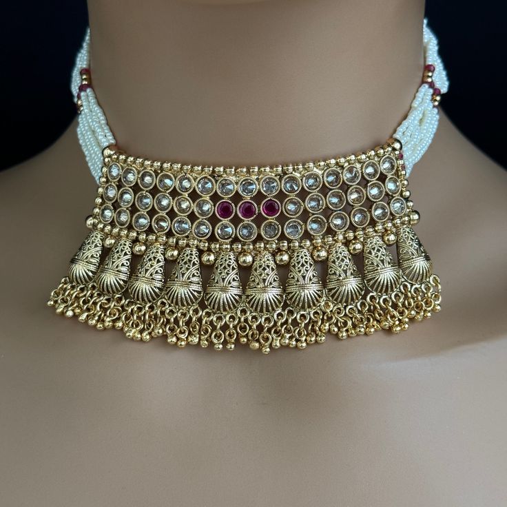 Ruby gold Polki Kundan choker Antique necklace wedding jewelry Indian Jewelry Pakistani Jewelry Wedding necklace Bridal necklace Regular Size And Adjustable Pearl Necklace Antique Necklace Set Dispatch in 1 business day Ships from California USA This is 100% Handmade jewelry. So the color, shades, and texture displayed may vary slightly from the actual product due to digital image limitations. We request you to consider these minor variations. Please expect the possibility of some slight imperfe Gold Bridal Necklace With Beads For Party, Heavy Gold Bollywood Necklaces, Gold Heavy Bollywood Necklace, Heavy Gold Bollywood Necklace, Intricate Design Choker For Receptions And Festivals, Intricate Design Choker For Reception And Festivals, Festive Pearl Choker Necklace, Gold Kundan Choker Necklace, Kundan Choker With Intricate Design