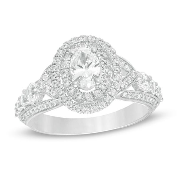 A sublime expression of love, this vintage-inspired diamond engagement ring is anything but ordinary. Crafted in 14K white gold, this luxurious choice showcases a 1/2 ct. oval-shaped diamond wrapped in a double diamond-adorned frame - all atop a gallery shimmering with diamonds. Along the shank, sculpted borders lined with diamonds and intricate milgrain detailing highlight a ribbon of graduated-sized diamonds and create "V"-shaped collars that flank centerpiece. Captivating with 1-5/8 cts. t.w. Oval Diamond Ring For Wedding And Anniversary, Timeless Oval Diamond Anniversary Ring, Oval Wedding Rings With Diamond Accents, Oval Brilliant Cut Diamond Ring For Wedding, Oval Diamond Ring With Center Stone For Anniversary, Oval Diamond Cut Ring For Anniversary, Oval Diamond Cut Anniversary Ring, Timeless White Cluster Ring For Anniversary, Heirloom Oval Diamond Wedding Ring