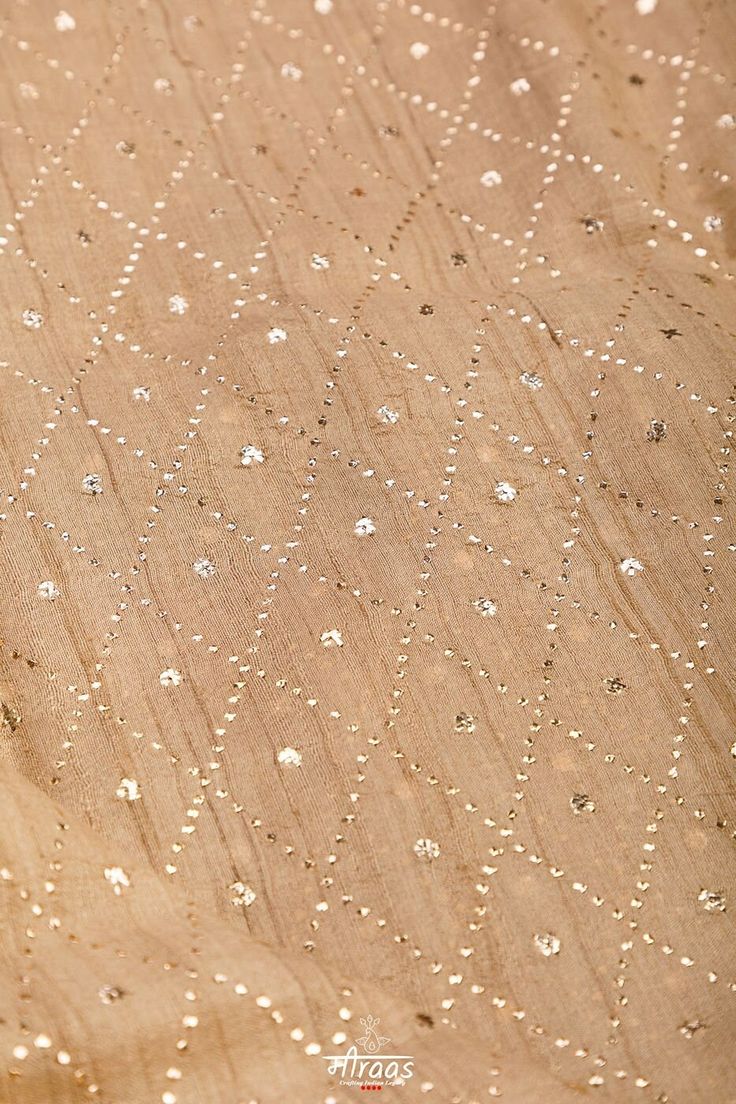 Champagne coloured divinity, crafted by hands!! Handloom Tussar Silk Dupatta hand embroidered beautifully with the Barfi (Quadrangle) Pattern in Mukaish Craft (Chheenta Mukaish and Tiki Mukaish) by rural women artisans of Lucknow, North India. The Dupatta is embroidered all over & finished with Gold kingri gota lace detailing (not visible in images) on the daaman (width end) of the Dupatta. The dupatta shade is natural beige colour of Tussar yarn. It is a beautiful Heirloom piece that works perf Gold Raw Silk Lehenga With Dupatta, Designer Gold Sharara With Zari Work, Gold Lehenga With Dupatta In Raw Silk, Gold Raw Silk Lehenga With Zari Work, Festive Gold Sharara In Raw Silk, Gold Raw Silk Sharara For Festive Occasions, Festive Gold Raw Silk Sharara, Gold Raw Silk Anarkali Set With Zari Work, Gold Unstitched Sharara With Resham Embroidery