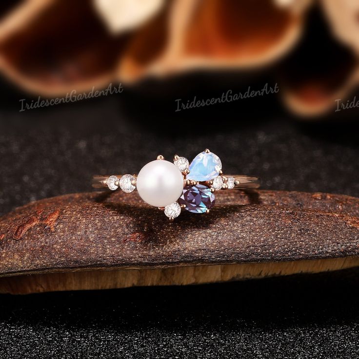 Akoya Pearl Engagement Ring Alexandrite Moonstone Ring Gold Moissanite Cluster Wedding Rings for Women June Birthstone Ring Pearl Jewelry Pink Sapphire Cluster Ring: https://www.etsy.com/listing/1737946965/dainty-akoya-pearl-engagement-ring-pink RING DESCRIPTION ✦Engagement Ring ✴Center Stone - Pearl Shape - Round Cut Size - 5mm ✴Side Stones - Alexandrite & Moonstone & Moissanite/Diamond Shape - Oval & Pear & Round  Cut Weight - 0.114 ct Clarity - SI-VS Color- G-H ✴Band Width - About 1.6mm ✴Ring Luxury Pearl Ring With Gemstone For Wedding, Multi-stone Diamond Pearl Ring For Wedding, Oval Multi-stone Pearl Ring For Wedding, Round Multi-stone Moonstone Promise Ring, Multi-stone Open Birthstone Ring For Wedding, Multi-stone Open Ring Birthstone For Wedding, Multi-stone Moonstone Promise Ring, Moonstone Multi-stone Ring For Anniversary, Anniversary Pearl Ring With Moonstone Gemstone