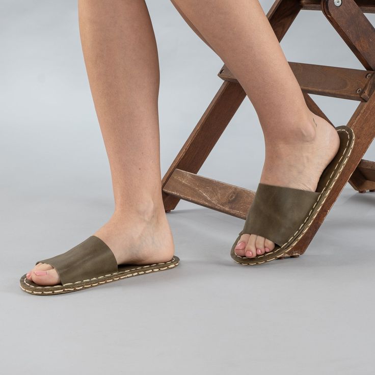 Introducing the Green Barefoot Slide Sandals - the perfect addition to your summer wardrobe. Handmade in Turkey with 100% natural materials, these sandals are crafted with a natural leather upper and a water buffalo leather sole, ensuring maximum comfort and breathability for your feet. With a wider toe box, your toes have enough room to spread and relax, promoting a more natural gait and posture. The "zero-drop" non-elevated heel helps maintain proper posture as well. Available in sizes ranging Beach Slip-on Slingback Sandals With Leather Sole, Summer Closed Toe Slippers With Leather Footbed, Closed Toe Slippers With Leather Footbed For Summer, Beach Clogs With Textured Sole And Round Toe, Summer Leather Slippers With Stitched Sole, Leather Slippers With Stitched Sole For Summer, Beach Sandals With Textured Sole And Single Toe Strap, Vacation Sandals With Textured Sole And Single Toe Strap, Vacation Slingback Sandals With Rubber Sole