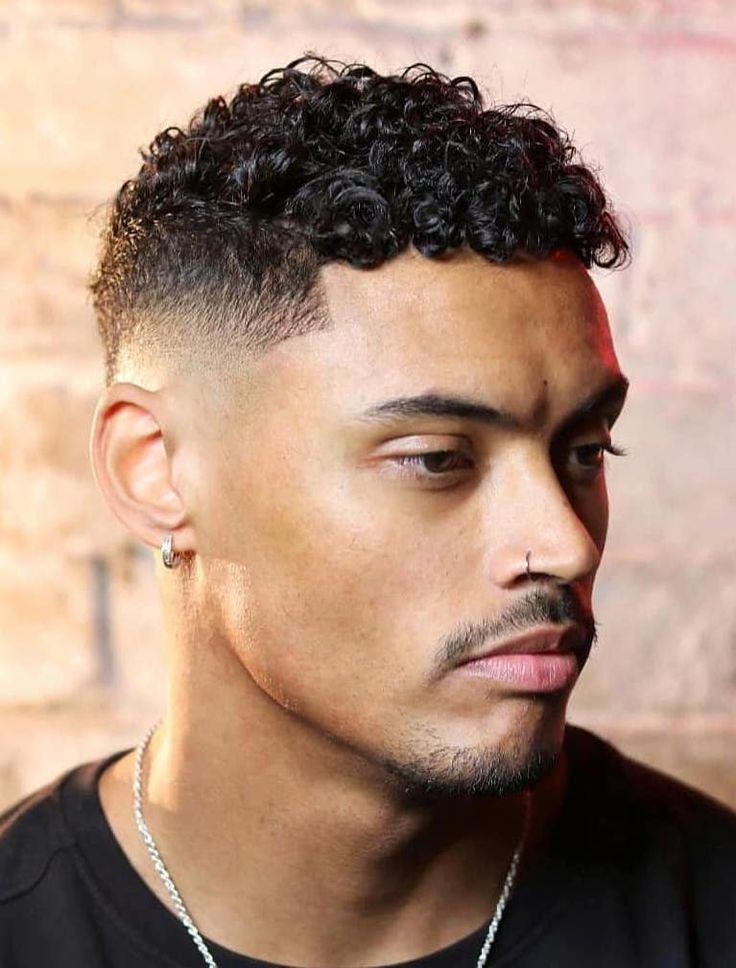 Perfect Mid Fade with Sharp Line Up - If you’re after a mid fade that’s great for curly hair, look no further. This style allows the hair’s curly nature to shine through and uses the mid fade to add tidiness. Skin Fade Haircut Men Curly, Haircuts Fir Natural Curly Hair Men, Men’s Curly Haircut Black, Mixed Hair Men Haircut, Mid Fade Haircut Curly Hair, Men Curly Hairstyles Black, Mid Fade With Curly Hair, Dominican Hairstyles Men, Curly Fade Haircut Men Black