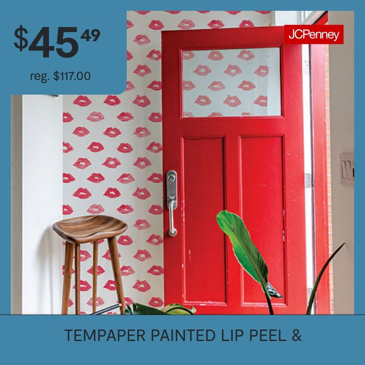 a red door with lips painted on it and a stool in front of the door