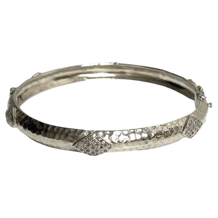 Description Your style comes to life wearing this unique, edgy and timeless sterling silver bracelet. Raised diamond shape appliques totaling 1.20 carats of pave diamonds encircle and embellish this stunning bangle. Artistically hammered by hand to create dazzling reflections when catching the light, it is sure to be a fashion-forward addition to your jewelry wardrobe. Along with its beauty, this hinged bracelet features a discrete and secure clasp. Item # B1221 If you prefer a wider bangle, see Dazzling Silver Diamond Bracelet In Platinum, Silver Platinum Diamond Bracelet With Single Cut Diamonds, Platinum Bangle Diamond Bracelet With Diamond Cut, Platinum Diamond Cut Bangle Bracelet, Platinum Bangle Diamond Bracelet, Luxury Silver Bracelets With Single Cut Diamonds, Silver Diamond Bracelet With Pavé Setting, Platinum Bracelets With Diamond Accents In Silver, Designer White Gold Bracelets With Single Cut Diamonds