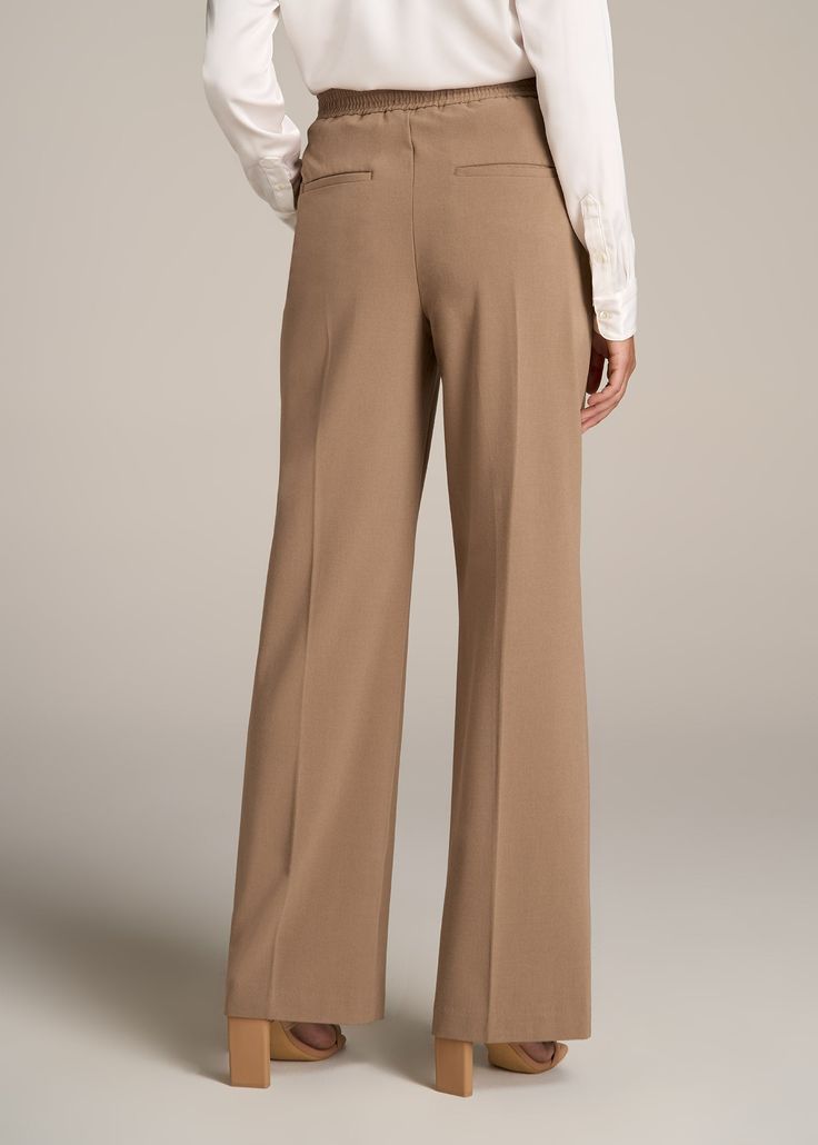 About Our Flat Front Wide Leg Dress Pants for Tall Women Ultra-flattering and easy to wear, these women's tall dress pants are a closet essential. They feature a smooth front with a contoured waistband for a complimentary finish. Pleated accents at the front and back elongate your legs and make them easy to wear from the desk to dinner. Built with a stretch-infused polyester-viscose blend, these pants for tall women offer the sleek feel of a suit with the comfort of a lounge pant. An elastic at Tailored Solid Color Wide Leg Full Length Pants, Versatile Tailored Full-length Dress Pants, Tailored Full Length Solid Wide Leg Pants, Tailored Full Length Wide Leg Pants, Fall Business Casual Wide-leg Dress Pants, Spring Classic Elastane Dress Pants, Classic Spring Dress Pants With Elastane, Classic Spring Dress Pants, Elegant Pants With 4-way Stretch For Spring