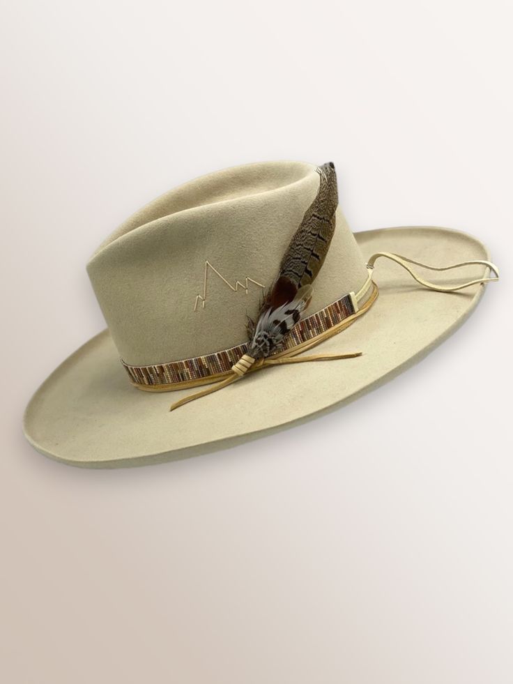 Western 50x in Bone Kettle curl on 3.5" brim Multi-sparkle hand loomed beaded band Feather Bundle magnet Hand stitched Mountain detail This felt hat is made to order, please allow 6-8 weeks for delivery. Luxury Fur Felt Fedora For Country Events, Cheap Casual Outdoor Hat Bands, Fitted Luxury Hat Band For Wedding, Western Wedding Hat With Feather, Cheap Classic Hat Bands For Spring, Adjustable Casual Hat Bands, Hat Bands Diy Ideas, Designated Marksman, Bohemian Hat