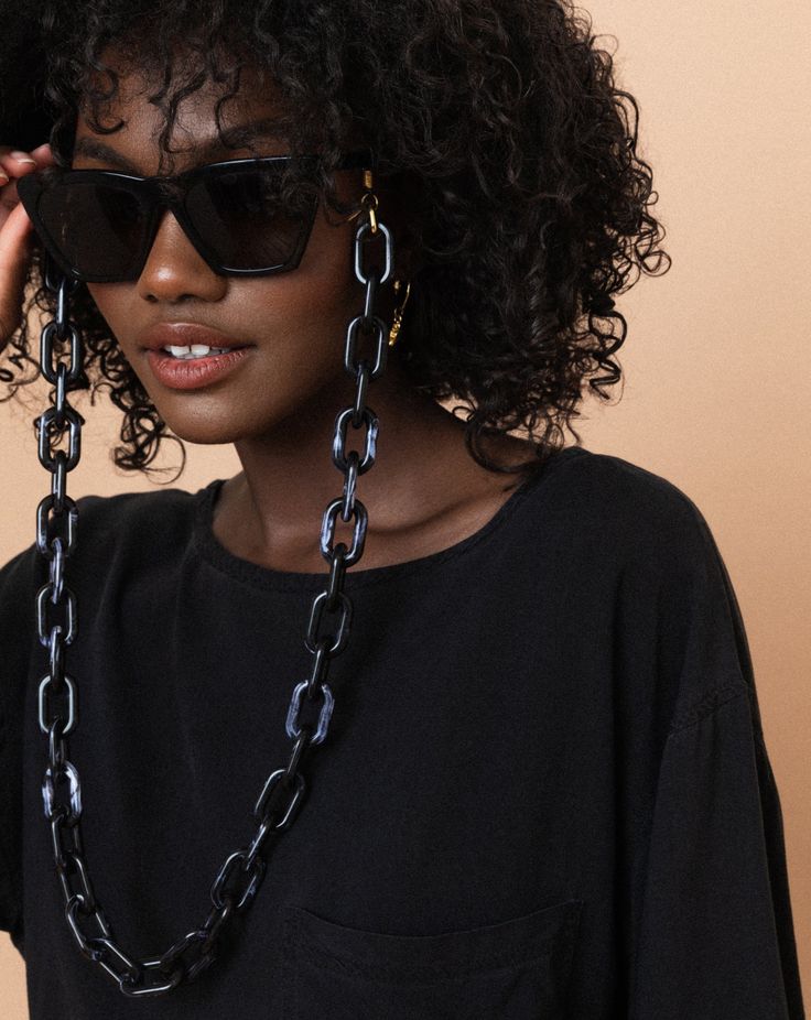 [forming a strong bond]What's more important than your sunglasses on a bright sunny day? Exactly, NOTHING. There is nothing worse than not having your sunnies when it's bright as hell, so these extra chunky chains are what you need to never misplace your glasses again. These eye-catching babies are the perfect accessory for your eclectic edgy self. So do yourself a favor and don't live without these any longer.•Extra chunky acrylic oval chains•Gold + clear rubber loop end•Gold oval ring to preve Trendy Summer Glasses Chains With Chain Strap, Black Adjustable Glasses Chains, Trendy Glasses Chains With Chain Strap, Trendy Black Glasses Chains As Fashion Accessory, Black Glasses Chains For Summer Beach, Black Glasses Chains With Adjustable Chain As Fashion Accessory, Trendy Black Glasses Chains For Everyday, Trendy Everyday Glasses Chains For Summer, Megan Walker