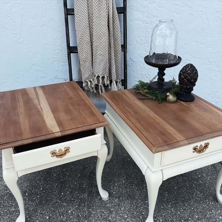 two white tables with wooden top sitting next to each other