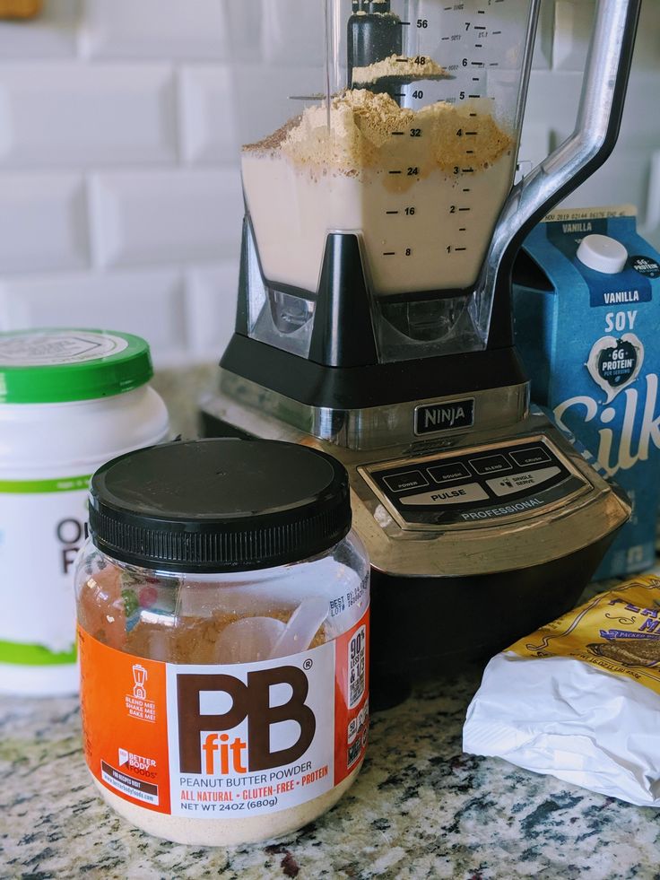 a blender filled with food sitting on top of a counter next to other ingredients