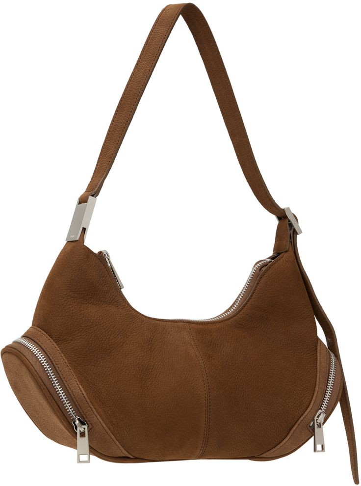 Nubuck shoulder bag in brown. · Adjustable shoulder strap · Zip pocket at sides · Zip closure · Patch pocket at interior · Brushed jersey lining · Logo-engraved silver-tone hardware · H8 x W13 x D4.5 Supplier color: Nubuck brown Modern Brown Bags With Silver-tone Hardware, Brown Crossbody Hobo Bag With Silver-tone Hardware, Brown Shoulder Bag With Silver-tone Hardware, Brown Satchel Hobo Bag With Silver-tone Hardware, Brown Crossbody Shoulder Bag With Palladium Hardware, Brown Satchel Hobo Bag With Palladium Hardware, Purses 2024, Cargo Bag, Silver Engraving