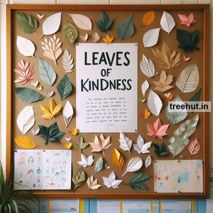 a bulletin board with leaves on it that says leaves of kindness and there is a tree in the background