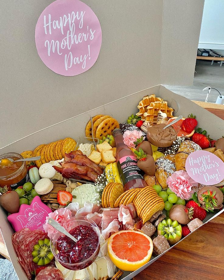 a box filled with lots of different types of food and condiments on top of a wooden table