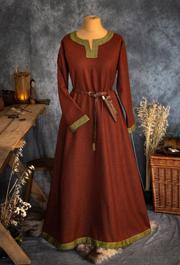 The dress has simple medieval cut with long sleeves, loose and comfortable. The historical pattern - an important element when playing historical realities, especially Vikings or Slavs. Put on your cloak and travel back to the Middle Ages. Hunting, ancient legends, the warmth of the hearth and our dress will give you an unforgettable experience. The simple cut of the dress allows you to move freely, as well as boldly add accessories to the dress. The dress will perfectly fit into the basic wardr Medieval Long Sleeve Dresses For Fall, Long Sleeve Medieval Dress With Historical Design For Fall, Fall Medieval Dress With Historical Design, Fall Medieval Dress With Long Sleeves, Vintage Long Sleeve Medieval Dress For Larp, Long Sleeve Dresses For Medieval Festivals, Winter Medieval Dress For Larp With Historical Design, Fall Dresses With Historical Design, Long Sleeve Brown Costume Dress