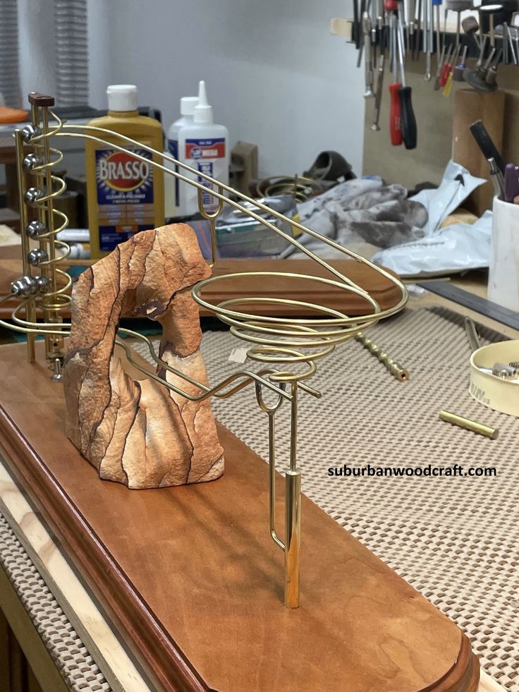 a wooden table topped with a metal object on top of a hard wood countertop