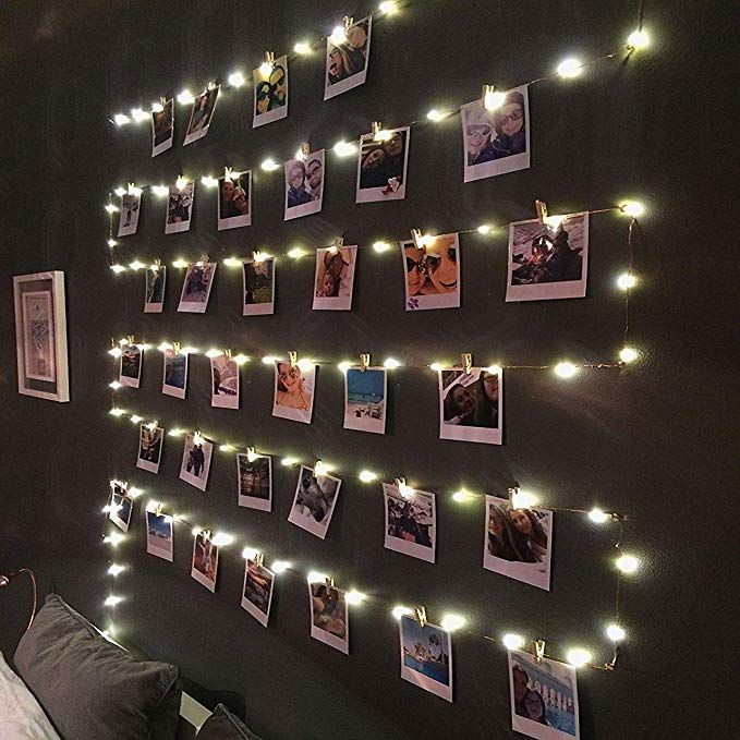 there is a wall with pictures and lights on it