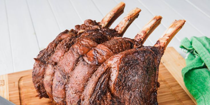 a large piece of meat sitting on top of a wooden cutting board