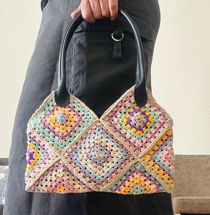 Ready To Ship 🌸 Add a pop of color to your ensemble with our vibrant knitted bag showcasing an array of soft hues. Handcrafted with care, this bag features a delightful rainbow of colors, perfect for adding a playful touch to any outfit. The bag is lined for durability and features a convenient snap closure to keep your belongings secure while on the move. Plus, it includes an interior pocket, providing added organization for your essentials. Whether you're running errands or heading out for a Multicolor Crochet Bag With Braided Handles For Shopping, Multicolor Crochet Bag With Braided Handles For Daily Use, Multicolor Square Shoulder Bag With Braided Handles, Multicolor Crochet Bag For The Beach, Multicolor Crochet Bag For Beach, Multicolor Crocheted Bag For Beach, Trendy Crochet Bag With Granny Square For Vacation, Trendy Multicolor Crochet Bag, Trendy Crochet Tote Bag With Granny Square Details