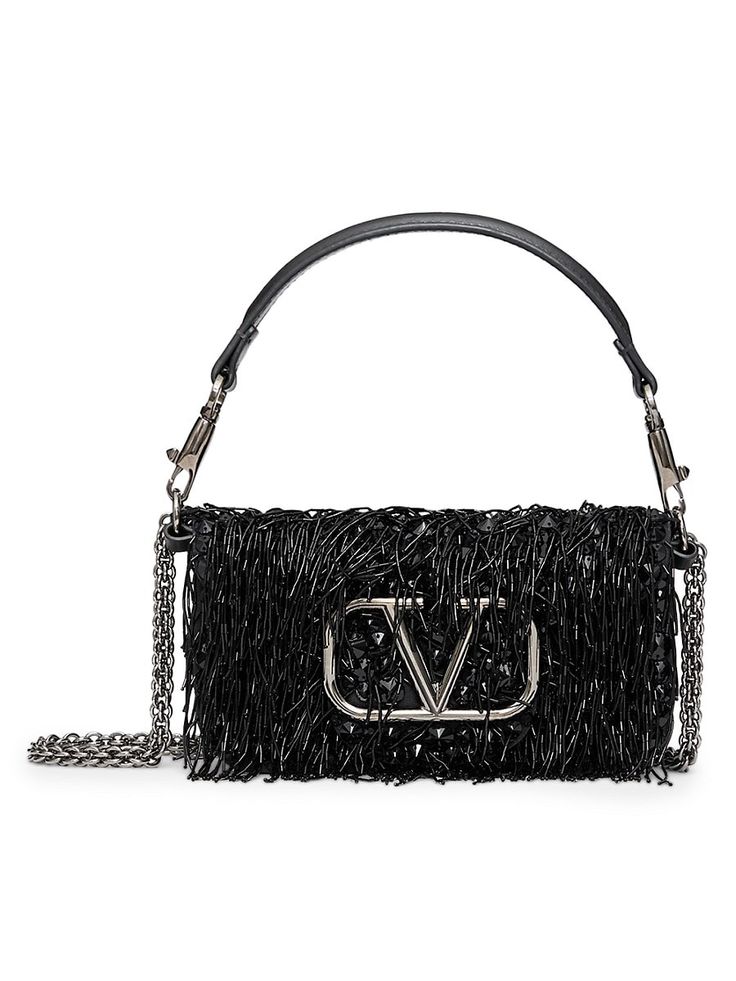 Find VALENTINO Locò Embroidered Shoulder Bag on Editorialist. The Valentino Garavani Locò small embroidered shoulder bag features beaded fringes and a metallic VLogo Signature detail. The bag is equipped with both a detachable sliding chain and a detachable handle, making it versatile for crossbody, shoulder, or handbag styles. The bag has ruthenium-finish hardware, a magnetic closure, and a removable leather handle. The shoulder strap features a removable sliding chain. The interior is lined with suede leather and includes one slip pocket. The shoulder strap drop length is adjustable from a minimum of 33 cm (12.9 in) to a maximum of 55 cm (21.6 in). The dimensions of the bag are W 20 x H 11 x D 5 cm / W 7.8 x H 4.3 x D 1.9 in. Made in Italy. Embroidered Shoulder Bag, Valentino Garavani Bag, Handbag For Women, Valentino Women, Iconic Bags, Shoulder Bag Black, Boot Pumps, Mua Sắm, Shoulder Handbag