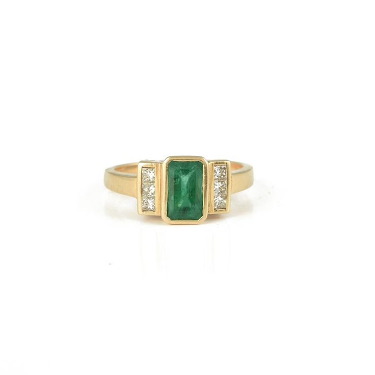 Product information- ~ Solid 14K Yellow Gold ~ Weight: 4.70 grams ~ Gemstone Weight-  1.440 ct (Emerald) and 0.250 ct (Diamond) ~ Genuine Emerald And Diamonds Gemstone  ~ Exclusive Designer Jewellery Healing with Emerald The ancient saints and sages have described a lot about the emerald stone benefits, its metaphysical properties and strong healing powers. They deeply believed that wearing a Panna stone benefits the individual by providing good health, wisdom, prosperity, creative skills and bl Green Emerald-cut Diamond Ring Channel Set, Green Emerald Cut Diamond Ring Channel Set, Classic Rectangular Emerald Ring With Center Stone, Classic Green Rectangular Diamond Ring, Emerald Cut Emerald Ring Channel Set, Channel Set Emerald Cut Emerald Ring, Classic Green Channel Set Emerald Ring, Emerald Cut Channel Set Emerald Ring, Classic Rectangular Emerald Ring For May Birthstone