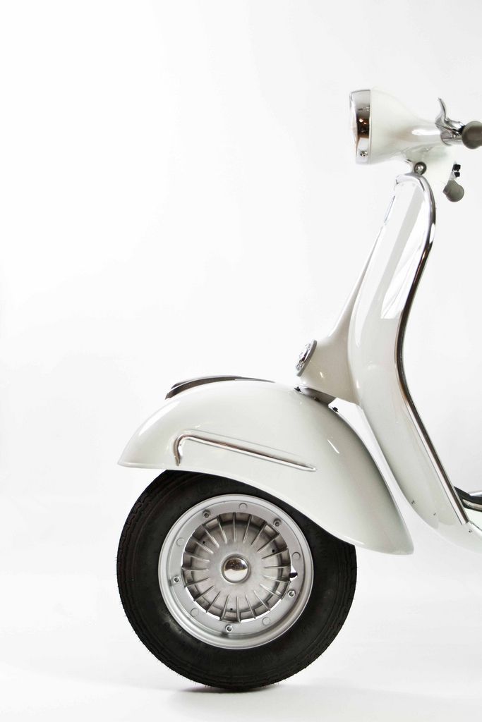 a white scooter is shown on a white background with no people around it