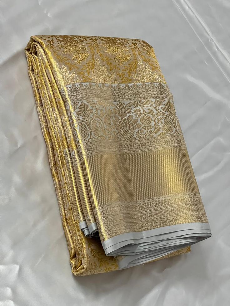 Bridal Collection Beige Color Pure Kanchipuram Silk Saree | Indian Traditional Ethnic Saree | Wedding or Party Wear Saree | Handwoven Gift Saree for Her Product Details : Saree Type : Pure Kanchipuram Silk Saree Golden Zari, Silk Mark Certified Blouse Piece : Yes (Un-Stitched) Saree Length : 5.5 Meters Blouse Piece Length : 80 cm Saree Weight : 0.9 kg Saree Fabric : Pure Kanchipuram Silk  Color : As shown in the picture Work : weaving Pattern : designer Occasion: Party Wear, Formal Wear, Festiva Gold Pre-draped Saree With Traditional Patterns For Festivals, Gold Brocade Pre-draped Saree With Zari Weaving, Gold Brocade Pre-draped Saree With Zari Work, Gold Pre-draped Saree With Cutdana For Navratri, Traditional Gold Pre-draped Saree For Navratri, Bollywood Style Gold Pre-draped Saree With Pallu, Traditional Gold Wear For Eid, Gold Traditional Wear For Eid, Semi-stitched Gold Jamawar Lehenga