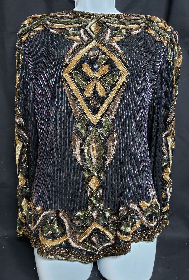 This gorgeous black blouse with several colored sequins and colored beads has a tag stating Oleg Cassini. It is a size large.  Measurements are Shoulder flat across is 17 inches,  Bust 20 1/2 inches flat across,      Waist 21 inches flat across,         Length  of blouse up and down starting from shoulder down is 22 inches. The geometric and curvelinear patches are gray, green and gold sequins. On black blouse open space are cylinder colored pink purple iridescent beads. The zipper works well bu Elegant Multicolor Evening Blouse, Fall Multicolor Embellished Tops, Black Embellished Party Blouse, Long Sleeve Beaded Party Tops, Party Black Embellished Blouse, Glamorous Multicolor Evening Tops, Embellished Multicolor Blouse For Party, Elegant Embellished Multicolor Blouse, Embellished Multicolor Party Blouse