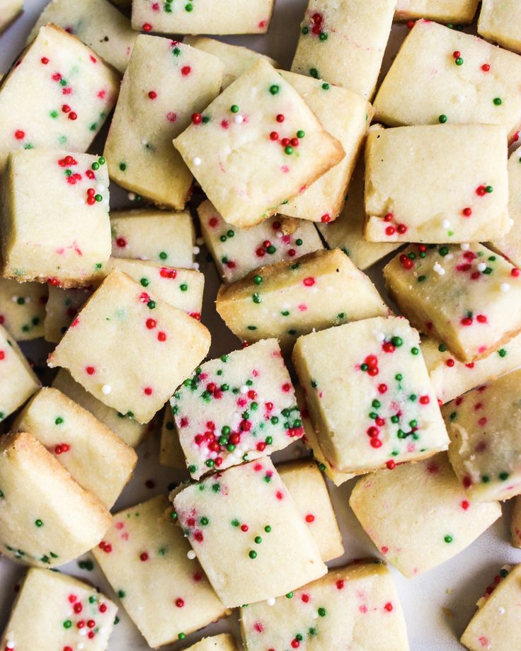 a white plate topped with shortbread cookies covered in sprinkles