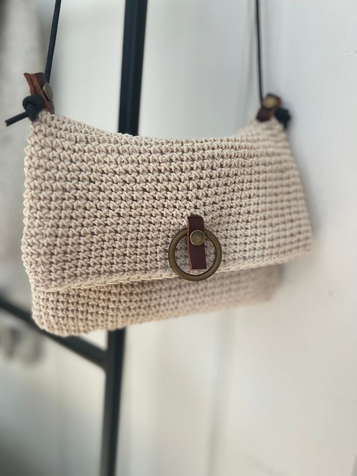 a purse hanging from a hook on a wall