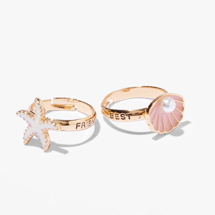 Celebrate your beach bestie with this fun set. These two adjustable rings have "Best" and "Friends" on each side, and one has an enamel starfish, and the other has a faux pearl-embellished seashell. Pack Size: 2 Finish: Gold-tone Fit: Adjustable Material: Metal - Claire's Best Friends Gold Starfish & Seashell Rings (2 Pack) Preppy Rings, Seashell Rings, Preppy Ring, Preppy Wishlist, School Wishlist, Beach Rings, Surf Jewelry, Beachy Jewelry, Summer Rings