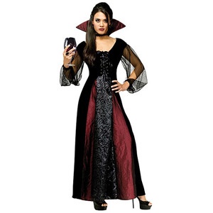 a woman dressed in a witch costume holding a wine glass and looking at the camera