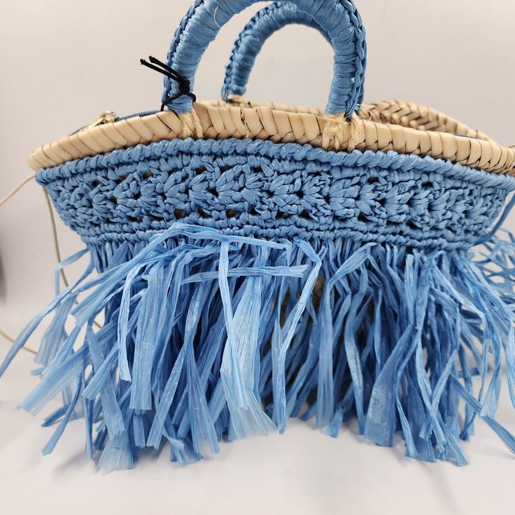 Caterina Bertini Fringe Mini Tote Bag In Blue Caterina Bertini Fringe Mini Tote Bag In Blue Retail $198 This Caterina Bertini Fringe Mini Tote Bag In Blue Is A Fashionable Addition To Any Woman's Collection. The Bag Features A Trapezoid Shape And A Blue Exterior Color. It Has Double Handles With A 5.12 Inch Drop And A Zip Closure For Security. The Bag Is Made Of A Woven Straw Exterior Material With A Viscose Nylon Blend Fabric Type And Has Gold Hardware Accents. The Bag Is Lined With A Blue Nylo Loungefly Purse, Fringe Tote Bag, Trapezoid Shape, Blue Exterior, Bags Game, Mini Blue, Boho Theme, Mini Tote Bag, Western Boho