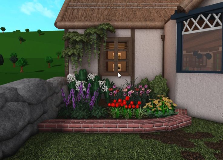 a small house with flowers in the front yard