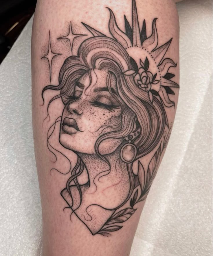 a woman's face with flowers and leaves on her thigh, done in black ink