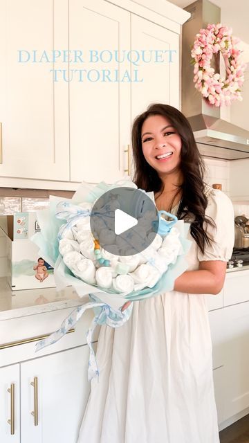 a woman in a white dress is holding a plate with eggs on it and the words diaper bouquet