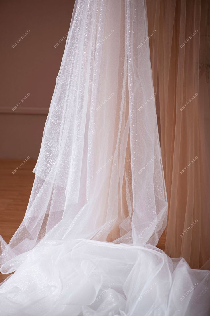 Perfect for wedding dress overlays and underlays, our premium shimmery glitter tulle fabric adds a touch of elegance to any formal gown, ensuring you shine on your special day. shown color: white sold by the yard content: polyester, PET light weight width: 150cm swatches: available Elegant Glitter Tulle Fabric For Wedding, Elegant Shimmer Tulle Fabric For Wedding, White Lace Tulle Fabric For Prom, White Tulle Fabric For Wedding, White Glitter Tulle Fabric For Wedding, White Glitter Tulle Fabric For Party, Wedding Glitter Tulle Fabric, For Wedding Dress, Overlay Dress