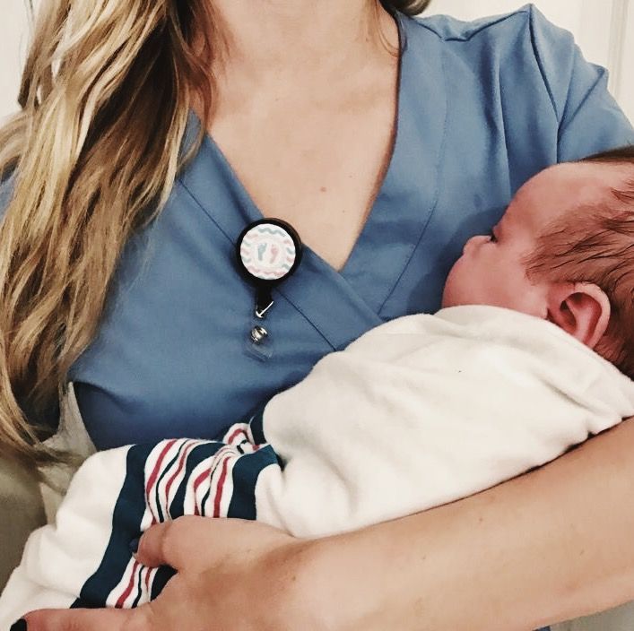 a woman holding a baby in her arms with a watch on it's wrist