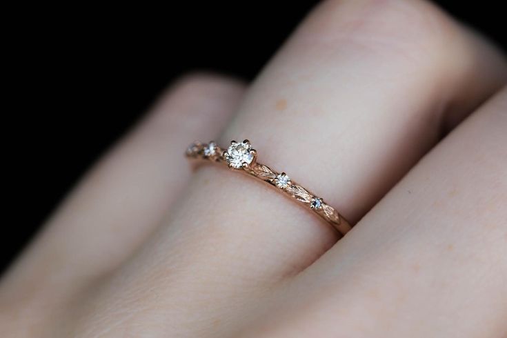 a woman's hand with a diamond ring on it