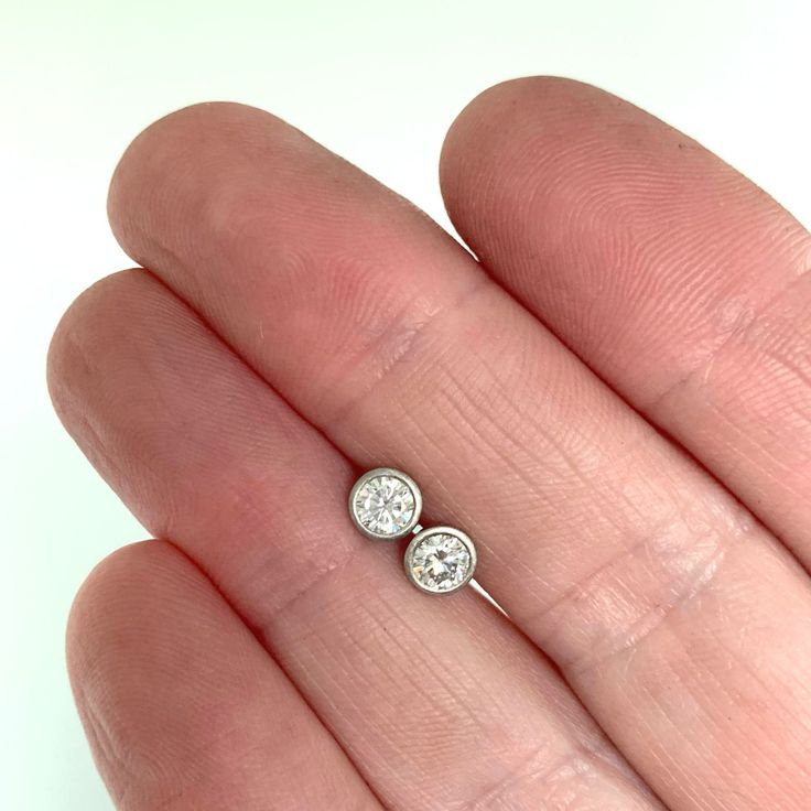 4 mm moissanite stud earrings, bezel set in 14k yellow, rose or white gold, or sterling silver. 14k white gold is pictured except for 6th photo which shows sterling silver. These earrings are made to order and will ship within 3-5 days. DETAILS - 4 mm moissanite - bezel setting - satin finish - solid 14k gold or sterling silver - white gold contains nickel, not rhodium plated - sold sterling silver or 14k gold backs - made to order within 3-5 days What is Moissanite? Moissanite is lab created si Classic Hypoallergenic Round Cut Jewelry, Everyday Bezel Set Round Cut Earrings, 14k Gold Round Bezel Set Earrings, Round Diamond Earrings With Bezel Setting, Minimalist Solitaire Sterling Silver Diamond Earrings, Sterling Silver Single Diamond Earrings Gift, Minimalist Sterling Silver Solitaire Diamond Earrings, Gift Sterling Silver Single Diamond Earrings, Minimalist Silver Diamond Earrings With Single Diamond