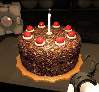 a chocolate cake with candles on it sitting on a table next to a camera and some other items