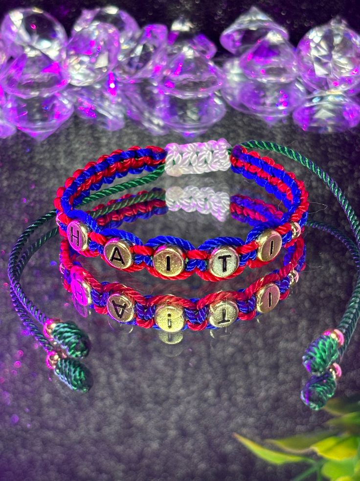 three different colored bracelets on top of each other